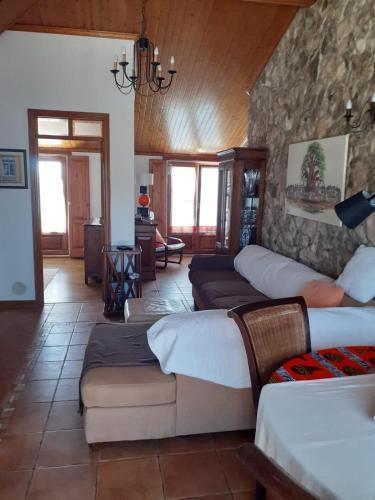 a living room with several beds and a couch at Casa Belo Horizonte in Lourinhã