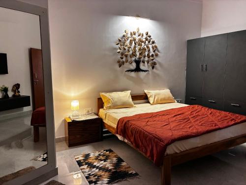 a bedroom with a large bed and a mirror at Baidehi Cottage in Rishīkesh