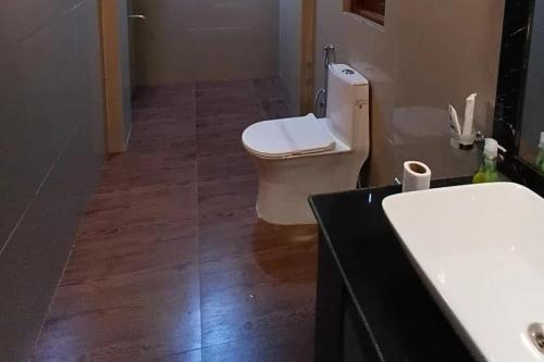 a bathroom with a toilet and a sink at Sacred Grove Homestay in Kalimpong