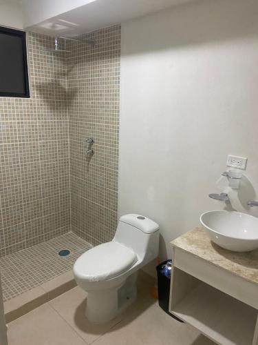 a bathroom with a toilet and a sink and a shower at Apartment with pool in Culiacán
