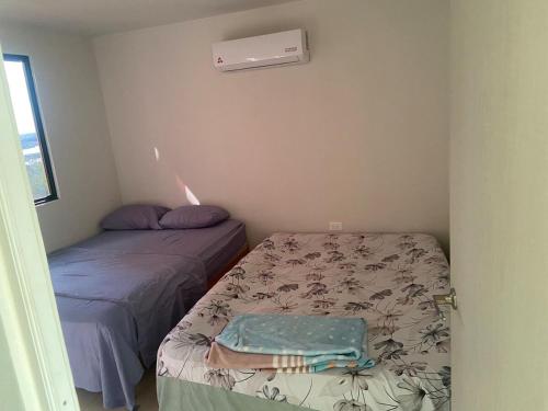 a small room with two beds and a window at Apartment with pool in Culiacán