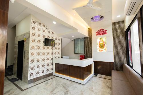 a lobby of a restaurant with a sink and tiles at Hotel Basil Inn in Ujjain