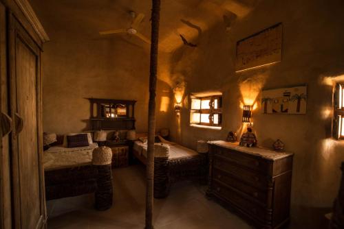 a bedroom with two beds and a dresser at Siwa Villa in Siwa