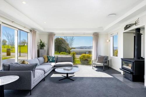 a living room with a couch and a fireplace at Fairhall view 
