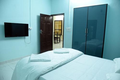 a bedroom with a white bed and a mirror at The Arena Edava in Paravūr