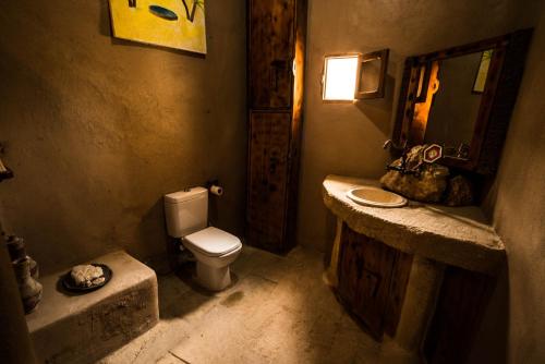 a bathroom with a toilet and a sink and a mirror at Siwa Villa in Siwa
