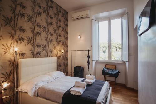 Ένα ή περισσότερα κρεβάτια σε δωμάτιο στο Circo Massimo stanze