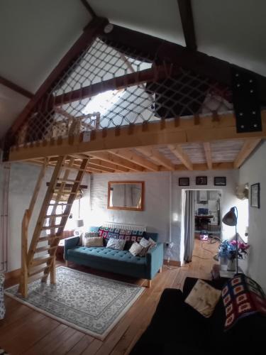 a living room with a loft bed and a couch at The Barn Square Island in Pembroke