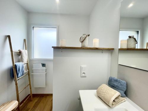 a small bathroom with a sink and a shelf at Loguel an placen in Saint-Laurent