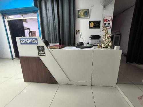 a reception desk with a sign that says rejection at Hotel O Sector 110 Noida Formerly Luv Kush Tower Bhangel in Noida