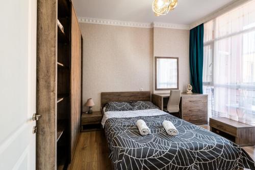 a bedroom with a bed with two pillows on it at Luxury 2 Bedrooms Apartment with 2 bathrooms & Batumi center in Batumi