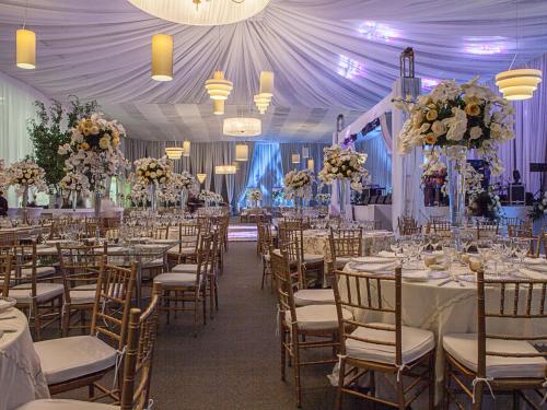 a banquet hall with tables and chairs and flowers at Las Americas Torre Del Mar in Cartagena de Indias