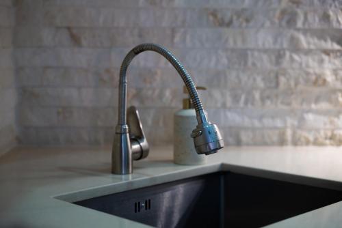 a kitchen sink with a faucet on a counter at Luxury 2 Bedrooms Apartment with 2 bathrooms & Batumi center in Batumi