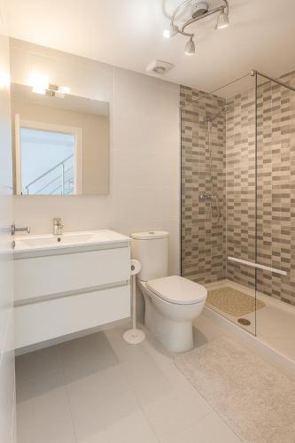 a bathroom with a toilet and a sink and a shower at 3 bedroom, two-level, morden apartment in Orihuela Costa