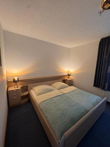 a bedroom with a large bed with two pillows at Hotel Restaurant Waldschlößchen in Neheim-Hüsten