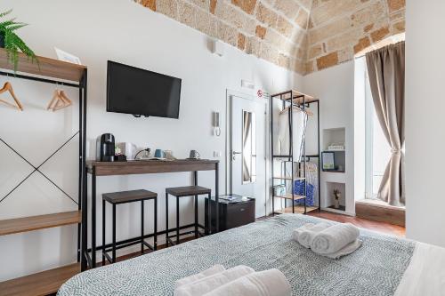 a bedroom with a bed and a bar in it at Tresor 39 in Polignano a Mare