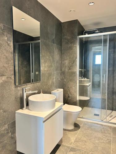 a bathroom with a sink and a toilet and a shower at Sunset Gardens - Holiday Apartments in Limassol