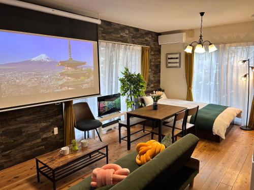 a living room with a room with a large screen at 88kawaramachi 一軒家 in Takamatsu