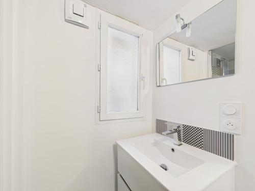 un bagno bianco con lavandino e specchio di 400m de la mer - grande maison pour 10 avec jardin a La Tranche-sur-Mer