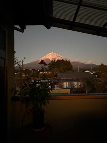 a view of a snow covered mountain from a window at Kitayama Fuji View House in Fujinomiya