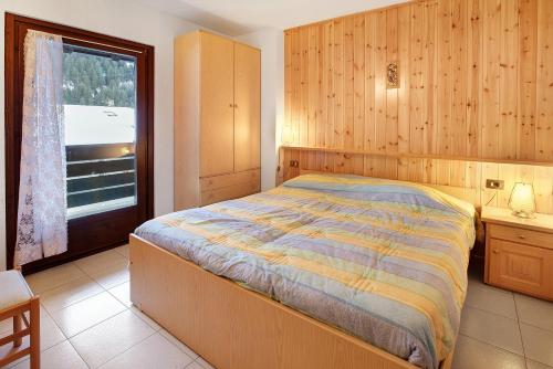 Ένα ή περισσότερα κρεβάτια σε δωμάτιο στο Appartamento vicino a Bormio