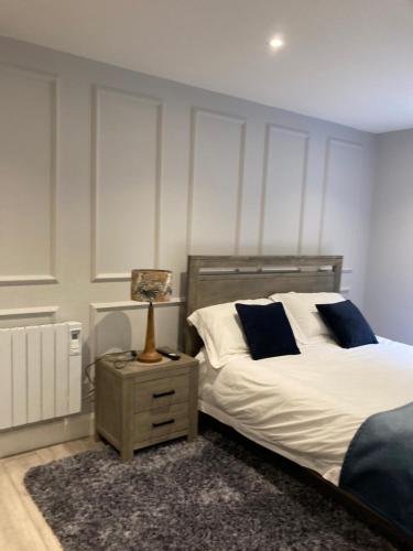 a bedroom with a bed and a lamp on a night stand at Dalys Place in Béal Átha Póirin