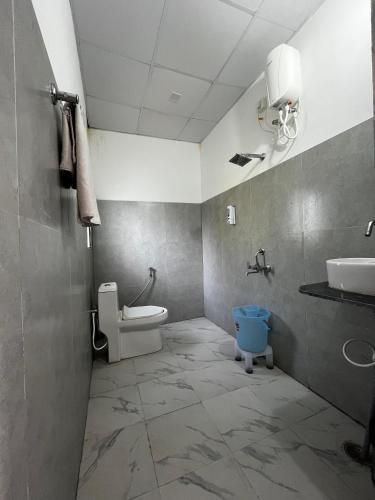 a bathroom with a toilet and a sink at The Corbett Niyas in Rāmnagar