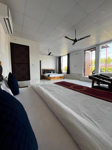 a large bedroom with a large bed and a table at The Corbett Niyas in Rāmnagar