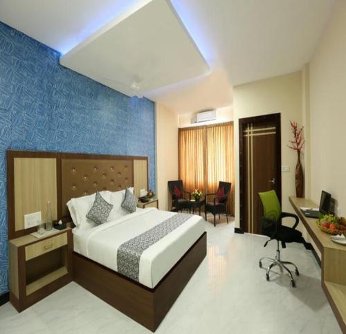 a hotel room with a bed and a desk and a room at TNV Casita Inn in Yercaud