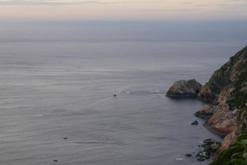 a view of the ocean from a cliff at NGO KHANH Homestay in Tân Hiệp