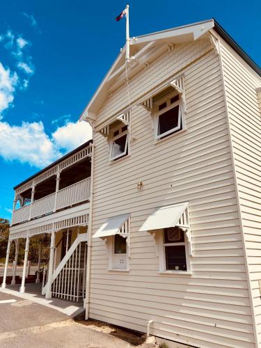 a white building with windows on the side of it at Point Lonsdale Guest House in Point Lonsdale
