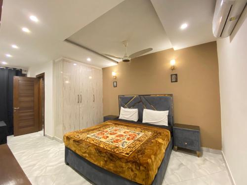 ein Schlafzimmer mit einem Bett in einem Zimmer in der Unterkunft 2 Bedroom Executive Suite in DHA Phase 8 in Lahore