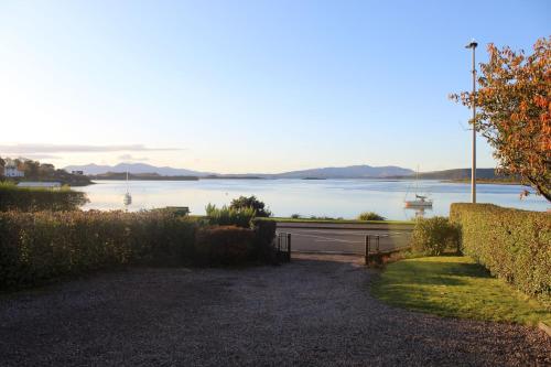 a view of a lake with a boat in the water at An Cala in Connel
