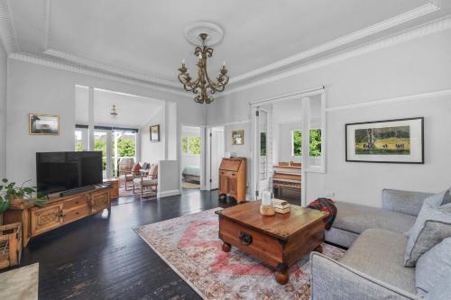a living room with a couch and a coffee table at The Sleepy Roo, Kangaroo Valley in Kangaroo Valley