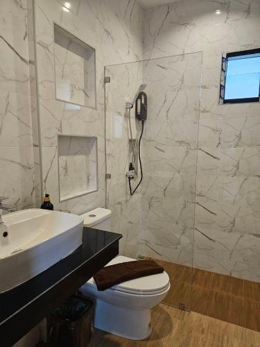 a bathroom with a sink and a toilet and a shower at Riverla Villa in Krabi
