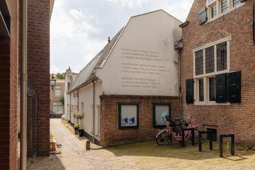 a building with bikes parked on the side of it at De Ooievaar in Naarden
