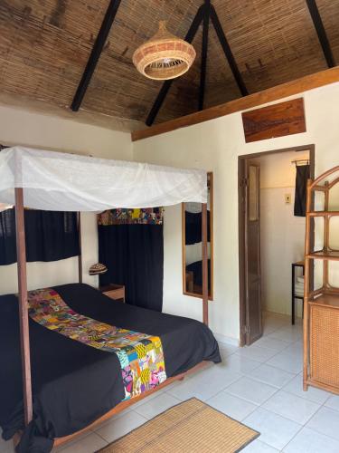 Ένα ή περισσότερα κρεβάτια σε δωμάτιο στο Campement teranga gandiole