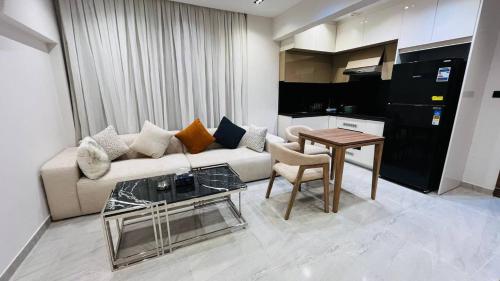 a living room with a couch and a table at كمبوند الكناريا عماره 81 in Sheikh Zayed