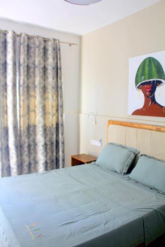 a bedroom with a bed with a green helmet on the wall at Residence A Paz in Boa Ventura