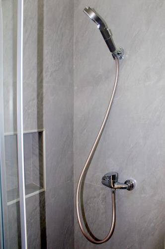 a shower with a shower head in a bathroom at Residence A Paz in Boa Ventura