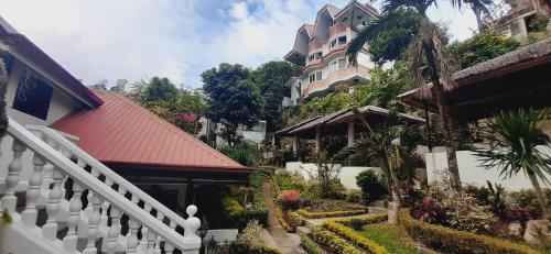 a building with a white fence in front of a building at Avana Hills Boracay Prime Residence Suite 201 in Boracay