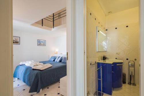 a small bedroom with a bed and a sink at Villa Elisa by My Villa Collection in Conca dei Marini