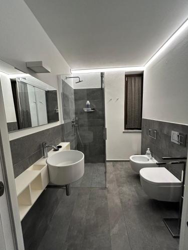 a bathroom with two sinks and two toilets at Maison Josephine in Aosta