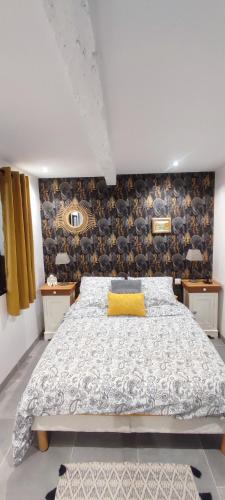 a bedroom with a bed with a yellow pillow on it at Studio Lindois in Lalinde