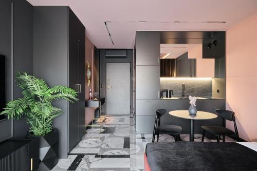 a kitchen and dining room with a table and chairs at INA Rent - Apartamenty Czysta Delux in Wrocław