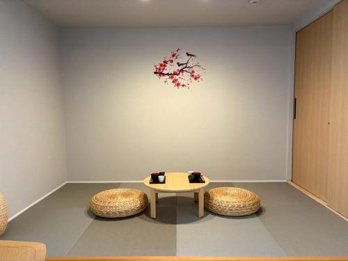 a room with a table and two stools at Koti Sopo Universal Bay 2 by Liaison in Osaka