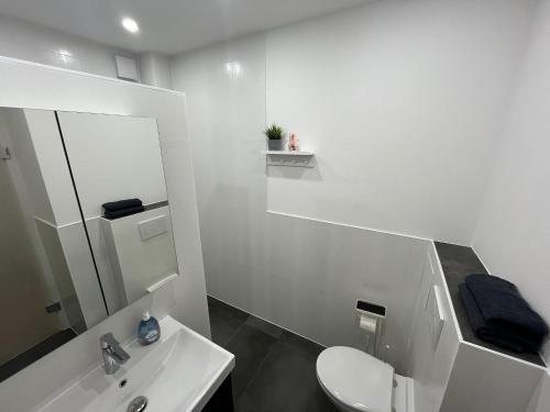 a white bathroom with a toilet and a sink at Live-In Room 6 - Klimatisiert - Coffee for free - in Karlsruhe