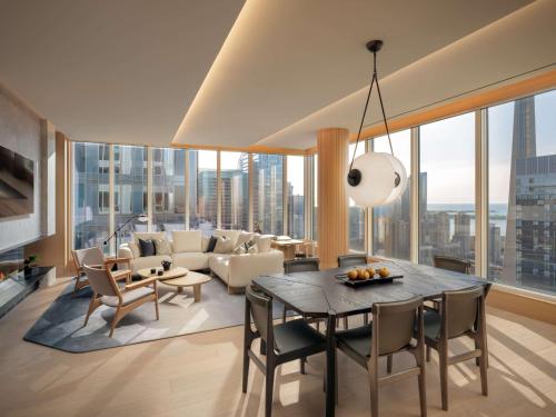 a living room with a table and chairs and a couch at Nobu Hotel Toronto in Toronto