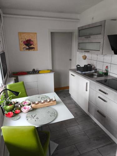 a kitchen with a table with vegetables on it at Ferienwohnung Luka in Kaulsdorf
