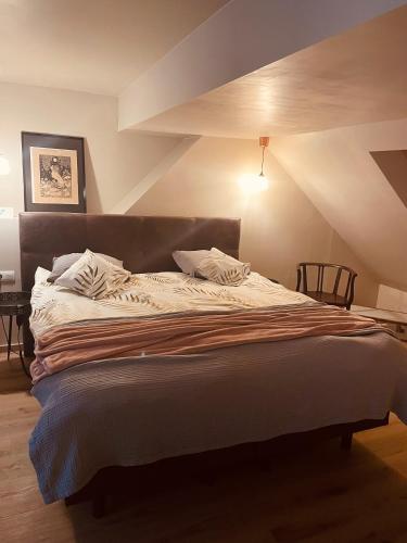 a bedroom with a large bed in a room at SkyNest in Namur